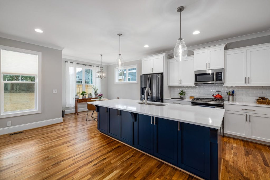 Mastering the First Impression: Your intriguing post title goes here Spacious kitchen featuring white cabinetry and wooden flooring, perfect for modern homes.